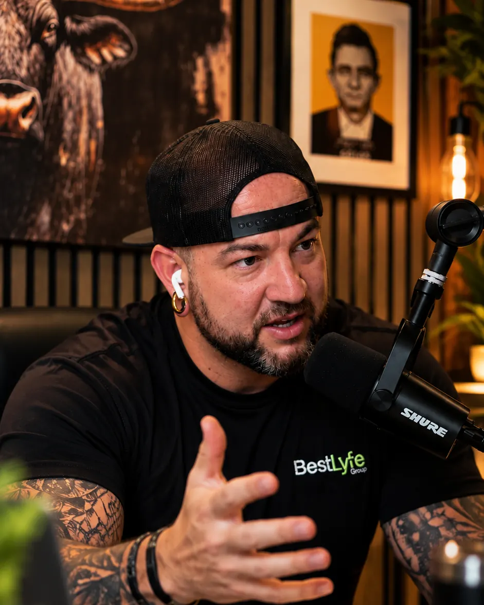 Dustin Lunde mid-conversation at the microphone in the Lyfe by the Horns studio